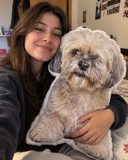 Woman hugging a shih tzu shaped pillow